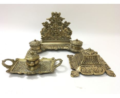 A reproduction brass letter rack with two inkwells and two other reproduction brass inkwells, some damage to ceramic well.