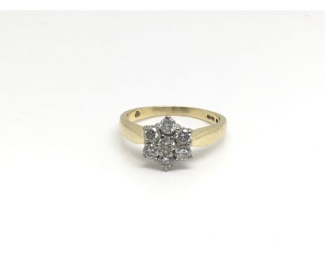 An 18ct yellow gold ring inset with seven diamonds in the form of a flower total weight approximately 3.7 grams, ring size ap