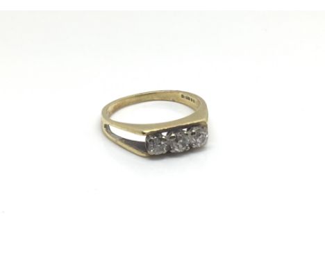 An 18ct gold ring inset with a row of three diamonds, ring size approximately J/K, total weight approximately 2.8 grams.