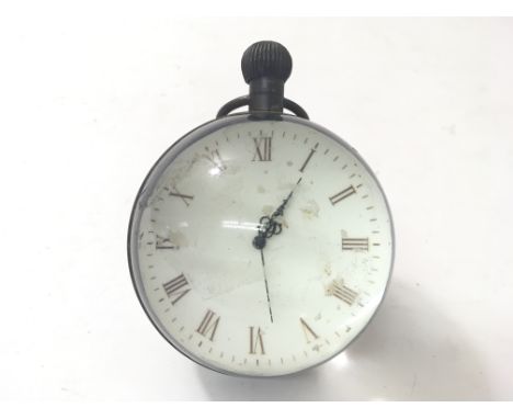 A table top magnifying clock with Roman numerals.