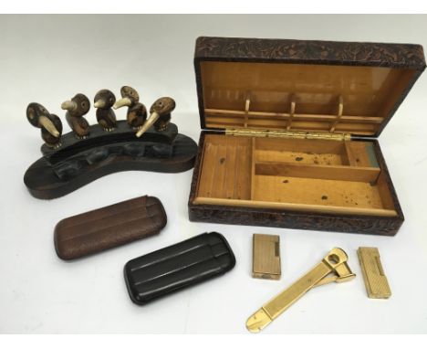 A Dunhill lighter, a DuPont lighter, a cigar cutter with 2 cigar cases and a novelty pipe rack.