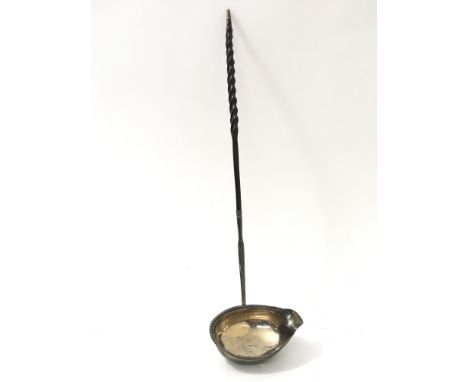 A Georgian silver toddy ladle with beaded edge and twist handle, London hallmarks