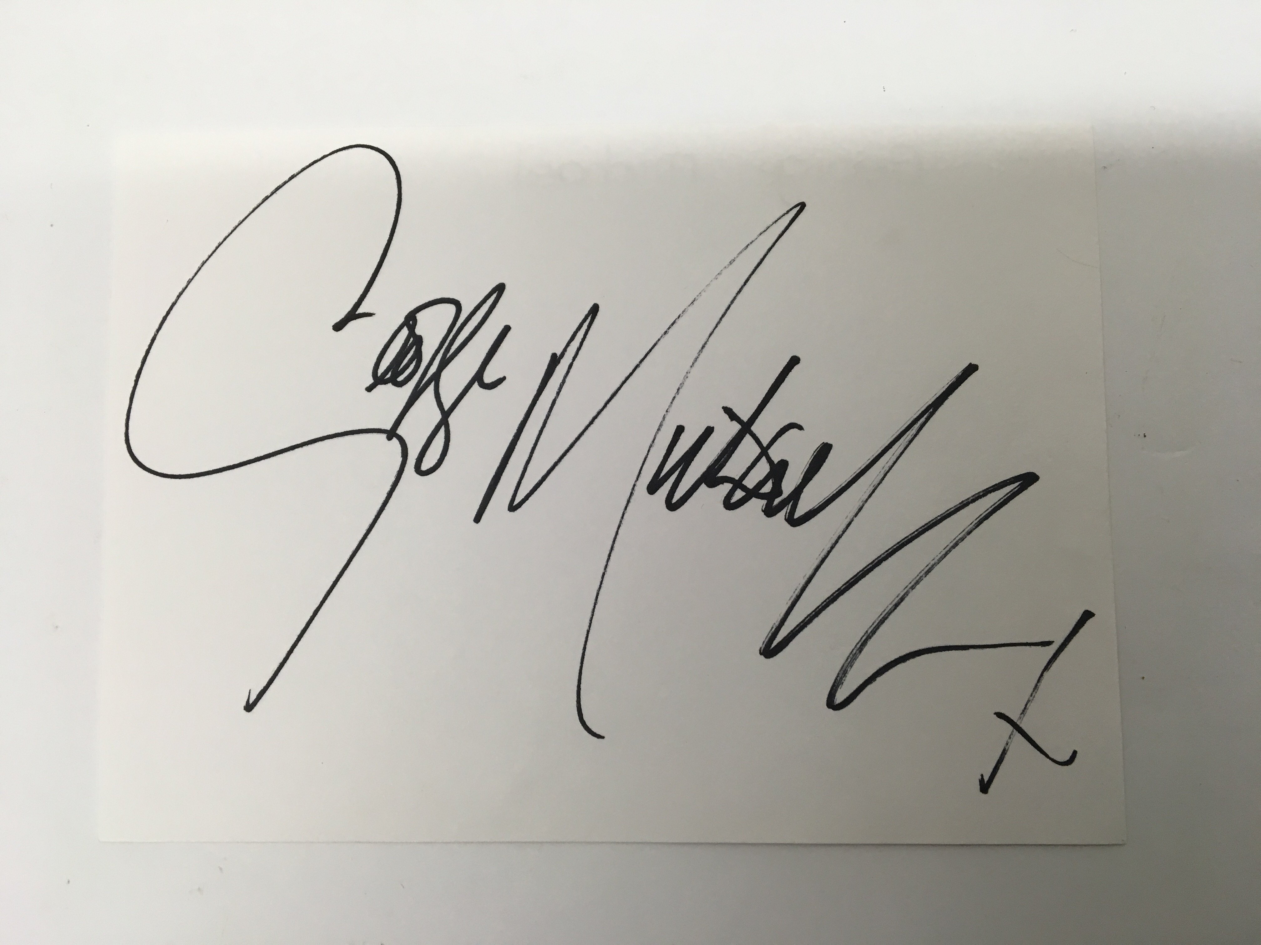 A white card signature of Michael.