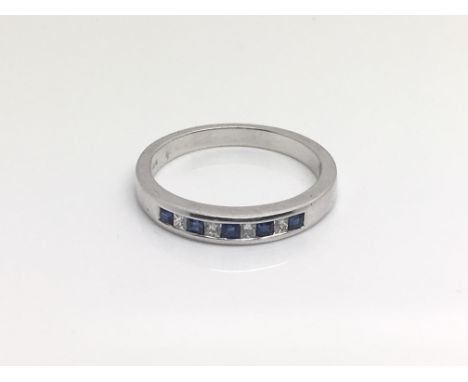 An 18ct white gold alternating sapphire and diamond ring, total weight approximately 3.5 grams, ring size approximately N.