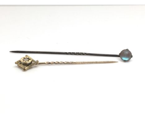 A 15ct yellow gold stick pin and a sapphiret stick pin, boxed, total weight approximately 1.8 grams.