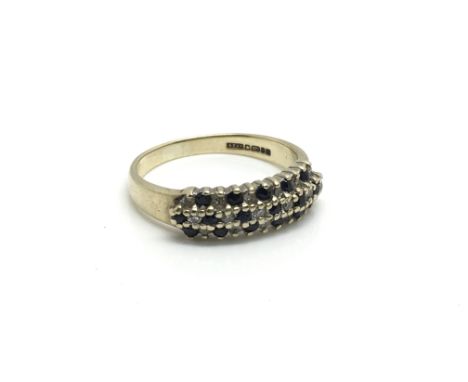 A 9ct gold ring inset with three rows of alternating diamonds and sapphires, ring size approximately O total weight approxima