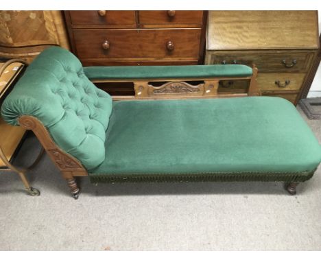 An Edwardian chaise longue with green fabric button back upholstery.
