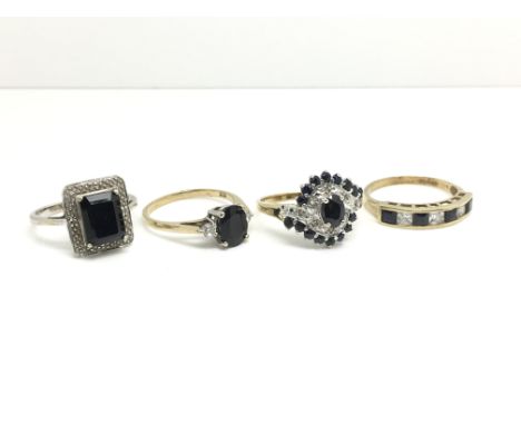 Four ladies rings to include three yellow gold rings all inset with white and dark stones, all in different configurations an