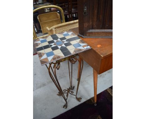A modern decorative metal plant stand with a tile top