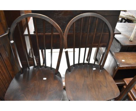 A set of four dark stained Ercol kitchen chairs, hoop and stick back