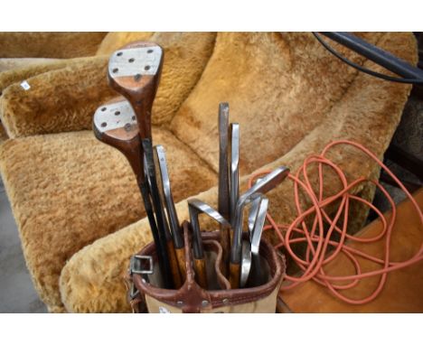 A selection of vintage golf clubs in bag