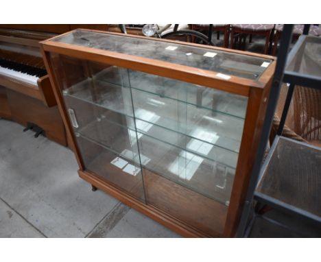 A vintage pitch pine display case with mirror back