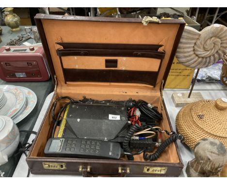 A VINTAGE MOBILE PHONE WITH CHARGER IN A BRIEFCASE 