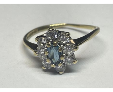 A 9 CARAT GOLD RING WITH A CENTRE BLUE TOPAZ STONE SURROUNDED BY CUBIC ZIRCONIAS SIZE I 