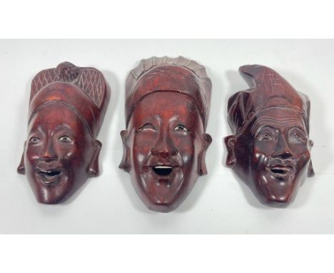 A SET OF THREE VINTAGE ORIENTAL HARDWOOD MASKS WITH BONE TEETH AND EYES, LENGTH 15 CM 
