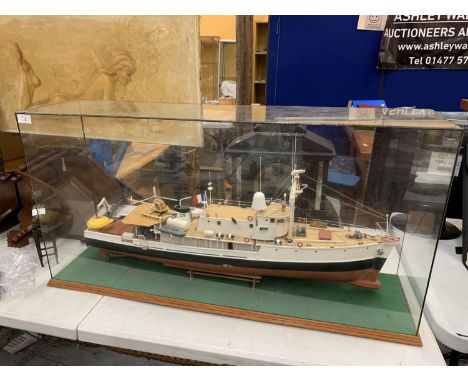 A LARGE MODEL OF A BOAT WITH HELICOPTER IN A GLASS CASE 