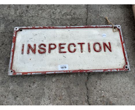 A VINTAGE CAST METAL 'INSPECTION' SIGN 