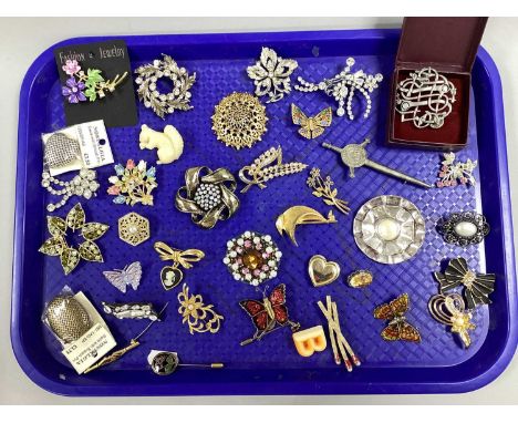 An Assortment of Costume Brooches and Stick Pins, to include gilt coloured, Kitsch style, diamanté, enamelled flower stick pi