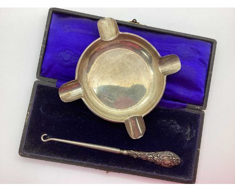 A Hallmarked Silver Ashtray, Walker &amp; Hall (marks rubbed) (65grams); together with a hallmarked silver handled button hoo