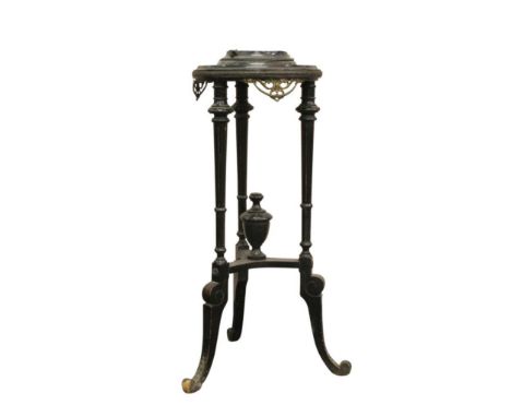 the circular top held on turned tripod supports and joined by a shaped urn stretcher, the body mounted with brass adornments,