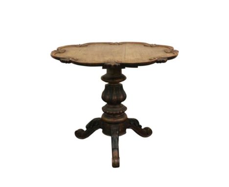 the pie crust top above a single turned support terminating in a tripod base with acanthus capped knees and scrolling toes, 6