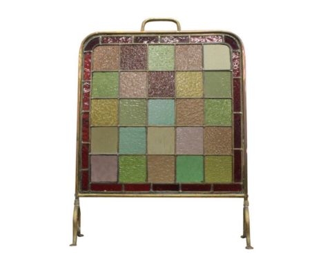 the brass frame enclosing the leaded light panel on lobed feet, 53.5 cm wide