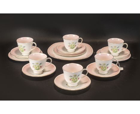 Wedgwood Susie Cooper Tea Set comprising six tea cups and saucers and a large cake plate.  All in delicate pale pink and whit