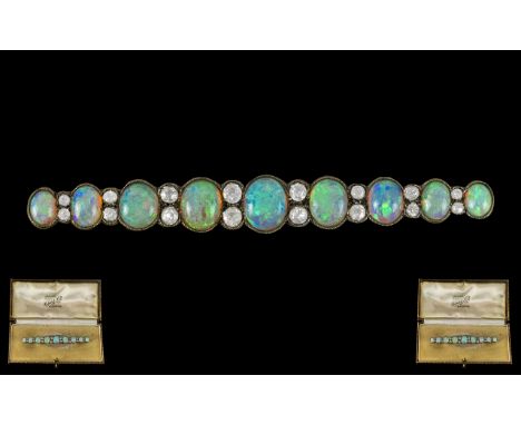 Antique Period Superb Quality Platinum Opal and Diamond Set Long Brooch of Graduated Form, Set with Nine Wonderful Natural Op