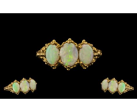 Ladies Attractive 9ct Gold 3 Stone Opal Set Ring.  Fully hallmarked for 9.375.  With ornate/fancy claw setting and shoulders.