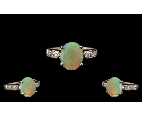 Ladies 14ct White Gold Attractive Opal and Diamond Set Dress Ring. Full Hallmark for 585 - 14ct. The Oval Shaped Opal of Exce