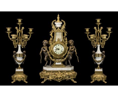 A 20th Century Brass And Marble Cased Clock Garniture In the Louis XV style, the movement by FHS of Germany. The circular ena