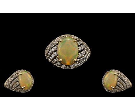 Ladies - Attractive and Pleasing 9ct Gold Opal and Diamond Set Dress Ring. Full Hallmark for 9.375. The Central Cabochon Cut 