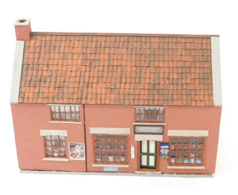 A model of a Pinchbeck grocery shop, MG Worthington, Grocer and Draper, in the early 1900's, scale 1:12, the two door front o