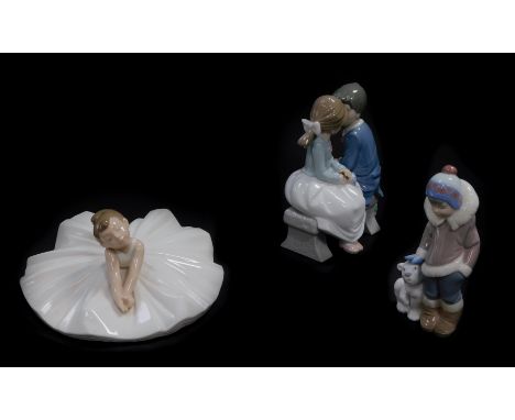 A Lladro porcelain figure of an Eskimo boy and polar bear cub, Nao figure group of a boy and girl seated on a bench, both box