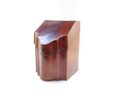 A George III serpentine mahogany knife box, with cross banded lid, plain interior, and moulded base, 35cm high, 26cm wide, 23
