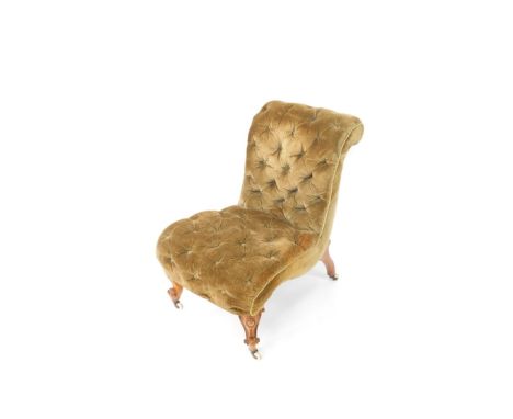 A Victorian walnut framed nursing chair, overstuffed in button green material, on cabriole front legs terminating in pot cast