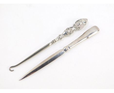 A Millennium silver paper knife, and an Edward VII silver handled button hook, with embossed foliate decoration, Birmingham 1