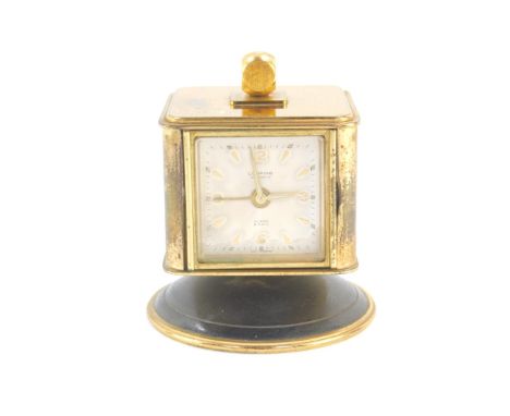 A Looping brass cased table clock, with thermometer, barometer, and hygrometer, the clock dial bearing Arabic numerals at qua