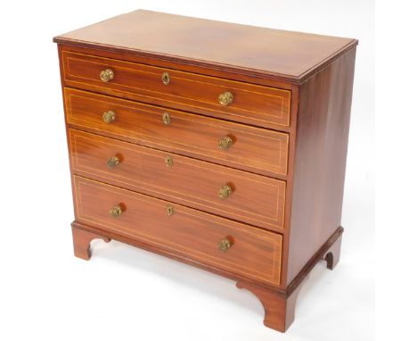 An Edwardian Sheraton revival mahogany chest, of four long drawers, each with brass knob handles and a boxwood stringing on o