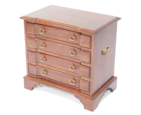 A 20thC mahogany finish chest, set with four inverted drawers with C scroll  handles on bracket feet, with side carrying hand