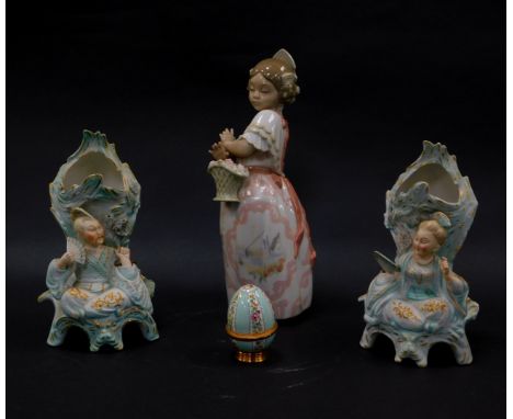 A Nao porcelain figure of a girl, modelled in traditional Spanish dress, with a basket of roses, (AF), together with an ename