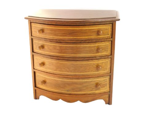 An apprentice mahogany bow front chest, of four long graduated drawers, with box wood line inlay, raised on bracket feet, 21.