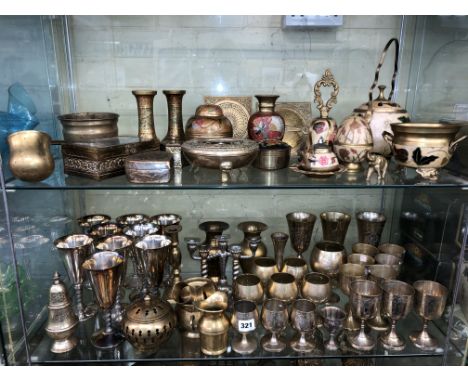 TWO SHELVES OF BRASS ENGRAVED GOBLETS, BRASS AND ENAMEL TEAPOTS BELLS, JARS AND COVERS, AND DECORATIVE BOXES