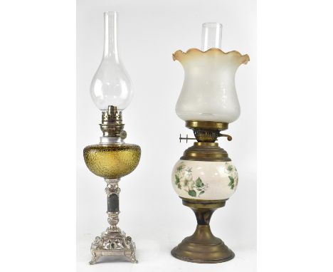 A Victorian-style oil lamp with amber and etched glass shade above a brass and ceramic base and one other siler plated and mo