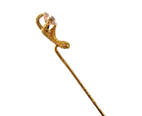 A 15ct gold tie pin in the form of an eagle's claw clutching a pink stone, stamped 15ct, approx 2g, in original box. CONDITIO