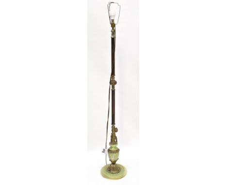 A green onyx and gilt metal mounted standard lamp, the base in the form of an urn with a putto, height 136cm.