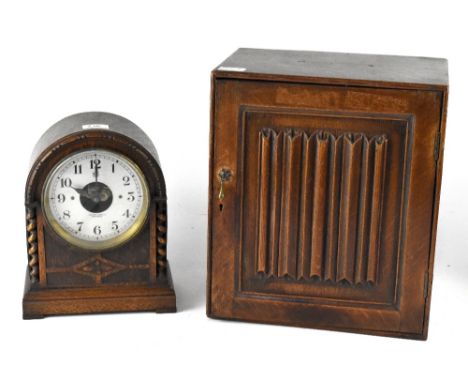 A 1930s oak cased mantel clock, the silvered dial set with Arabic numerals, signed Edmund Crouch of Worthing, enclosing a Bul