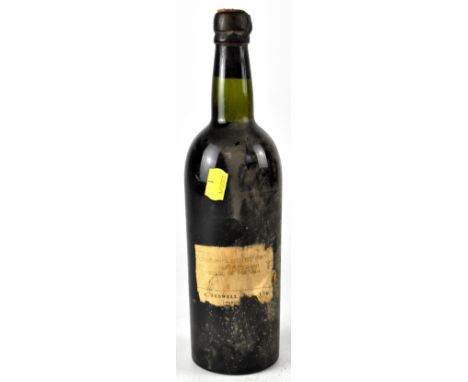 A vintage bottle of Cockburn's Crusted Port, the paper label states it was bottled in 1950, product of Portugal.