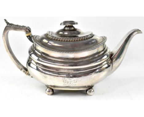 A George IV hallmarked silver teapot of melon shape, with acanthus leaf thumb kick, two ivory insulators to the handles, engr