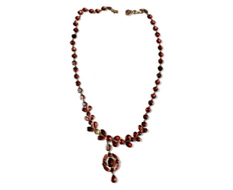 A vintage 9ct gold necklace and pendant, the Edwardian styled necklace set with various shaped red stones to represent flower